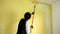 Colombian painting walls with a roller. Home renovation work. Wall paint application.