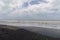 Colombian palomino beach landscape with black sand and cloudy day