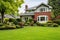 colonial brick house with a healthy, green front lawn