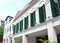 Colonial Building with Green coloured wooden windows