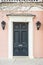 A colonial era door with gas lanterns and a mail