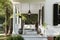 colonial house with front porch swing and hanging lanterns