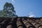 Colonial roof with clay tiles and blue sky