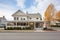 colonial with side porches, cobblestone driveway