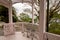 Colonial style wooden pink terrace in Glover Gareden with old stylish chairs and trees in the background, Nagasaki, Japan.