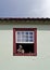 Colonial window with local handicrafts, painted ceramic sculpture, called sweethearts in Sao Joao del Rei, Brazil