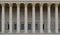 A colonnade of a public law court. A neoclassical building with a row of corinthian columns.