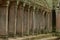 Colonnade of stone pillars in ruined temple