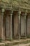 Colonnade of stone pillars under mossy roof