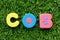 Color alphabet letter in word COB abbreviation of close of business on green grass background