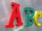 Color alphabet letters on silver metal,