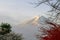Color of autumn leaves and Mt.Fuji with misty in the morning at