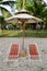 Color beach chairs and white umbrella