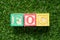 Color block in word Abbreviation of Free of charge on artificial green grass background