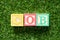 Color block in word COB abbreviation of close of businesson artificial green grass background