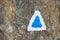 Color close up of a blue touristic marking on a rock