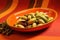 color contrast image of pistachios on an orange plate