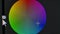 Color correction circle wheel on the monitor screen close up. Pixels zoomed in with red, blue, and green glowing