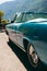 Color detail a vintage car sky blue color and shiny chrome, selective focus, turquoise, vertical photo