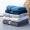 Color harmony Blue, white, and gray towels stacked, creating a stylish ensemble