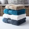 Color harmony Blue, white, and gray towels stacked, creating a stylish ensemble