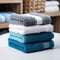 Color harmony Blue, white, and gray towels stacked, creating a stylish ensemble