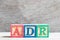 Color letter block in word ADR adverse drug reaction on wood background