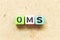 Color letter block in word OMS Abbreviation of Order management system or Operations management system on wood