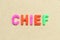 Color letter with word chief on wood background