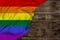 Color LGBT rainbow flag, Pride flag, beautiful silk, background old wood, concept of tourism, economy, politics, emigration,