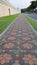 color Long paved brick footpath, Brick path or sidewalk with perspective going into the distance