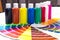 Color palette, tubes of paint on white wooden background