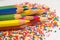 Color pencils on the background of texture multi-colored balls close-up. Set for children`s creativity and development