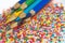 Color pencils on the background of texture multi-colored balls close-up. Set for children`s creativity and development