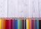 Color pencils in the background in white and gray wood, close up. Set of colored pencils, copy space. Color pencils. Top view,