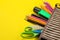 Color pencils in a school pencil case on a bright paper yellow background. Office tools. education