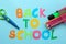 Color pencils and text back to school on a bright blue paper background. Office tools. education. . top view