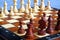 Color photo of chess Board and chess pieces, wooden chess pieces on the chessboard. Rook in the foreground. Soft focus. Blurred ba