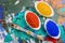 Color pigments in porcelain bowls on a wooden palette