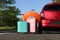 Color suitcases and inflatable ring near family car on highway