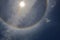 Color sun halo ring at noon on cloudy sly