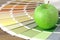 Color swatch on a table with green apple