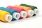 Color thread reels over white background