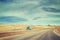 Color toned picture of American highway landscape with semi trailer truck