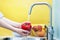 Color and vivid shot as a young woman thoroughly washes vegetables