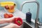 Color and vivid shot as a young woman thoroughly washes vegetables