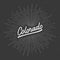 Colorado hand lettering with sunburst lines on gray background