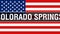 Colorado Springs city on a USA flag background, 3D rendering. United states of America flag waving in the wind. Proud American