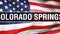 Colorado Springs city on a USA flag background, 3D rendering. United states of America flag waving in the wind. Proud American
