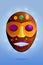 Colored african wooden mask on blue background